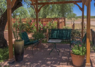 Photo of chairs and table under a Ramada in the BUU garden